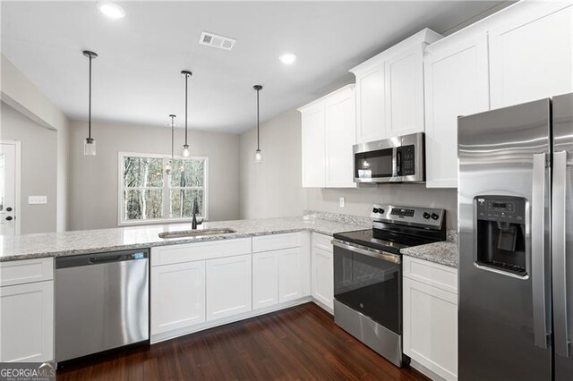 5726 Ridgewater Cir, Gainesville, GA 30506 - kitchen with light stone counters, a sink, dark wood finished floors, stainless steel appliances, and visible vents