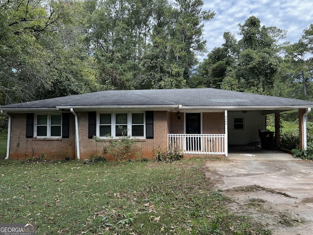 ranch-style home featuring a porch, driveway, a front yard, brick siding, and an attached carport