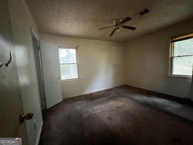 unfurnished bedroom featuring multiple windows and visible vents