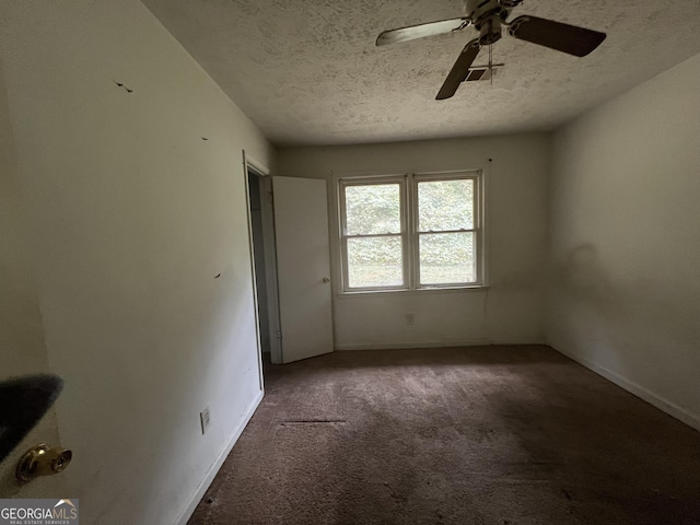 unfurnished bedroom with baseboards, ceiling fan, carpet floors, and a textured ceiling