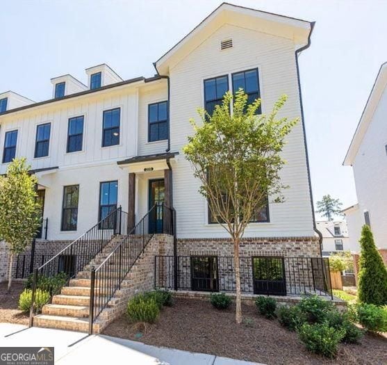 townhome / multi-family property with brick siding