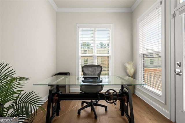 office area with baseboards, plenty of natural light, and wood finished floors