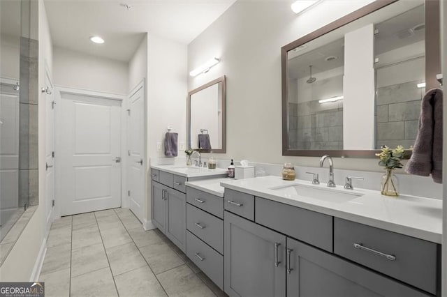 bathroom with a sink, double vanity, and tiled shower