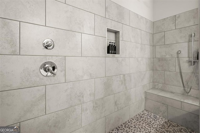 bathroom with tiled shower