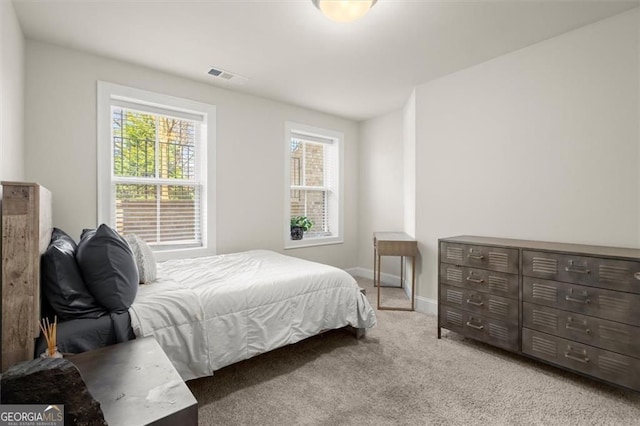carpeted bedroom with baseboards and visible vents
