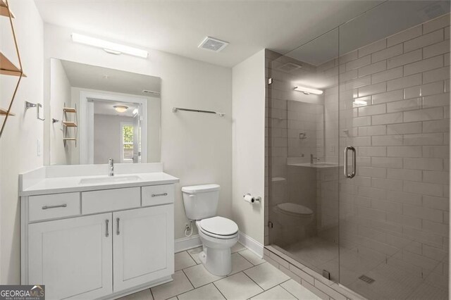 full bath featuring toilet, vanity, visible vents, tile patterned flooring, and a shower stall