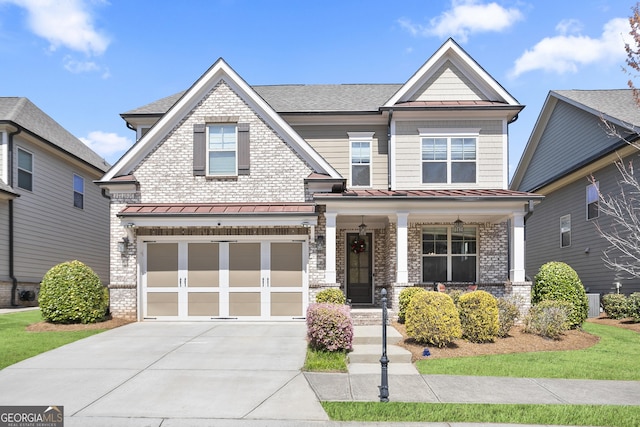 11395 Crestview Ter, Johns Creek, GA 30024 - craftsman-style home featuring covered porch, a standing seam roof, a garage, driveway, and roof with shingles