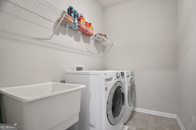 11395 Crestview Ter, Johns Creek, GA 30024 - laundry room with washer and clothes dryer and baseboards