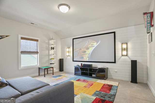11395 Crestview Ter, Johns Creek, GA 30024 - home theater room featuring carpet flooring, lofted ceiling, wooden walls, built in shelves, and baseboards