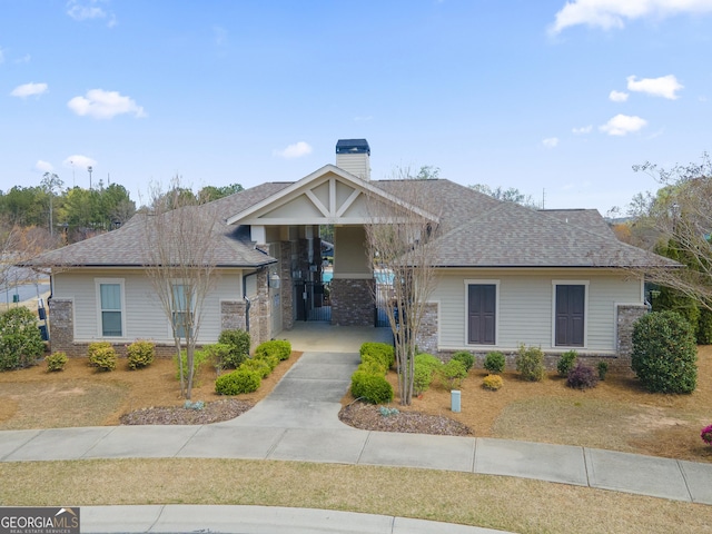 11395 Crestview Ter, Johns Creek, GA 30024 - view of front of house with a chimney, a shingled roof, and brick siding