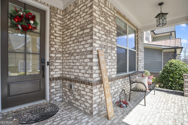 11395 Crestview Ter, Johns Creek, GA 30024 - doorway to property with brick siding, covered porch, a standing seam roof, and metal roof