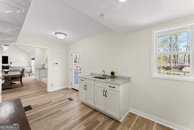 385 Jayne Ellen Way, Alpharetta, GA 30009 - kitchen with a sink, light wood-type flooring, baseboards, and healthy amount of natural light