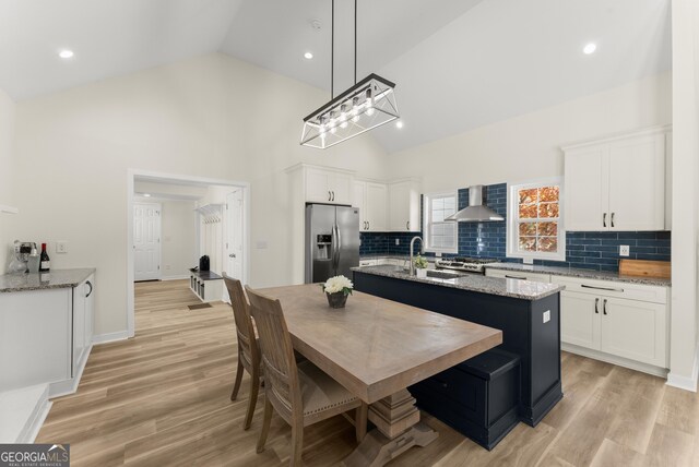 385 Jayne Ellen Way, Alpharetta, GA 30009 - kitchen with stainless steel fridge with ice dispenser, wall chimney range hood, a sink, white cabinets, and high vaulted ceiling