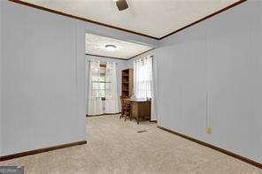 empty room featuring carpet flooring and baseboards