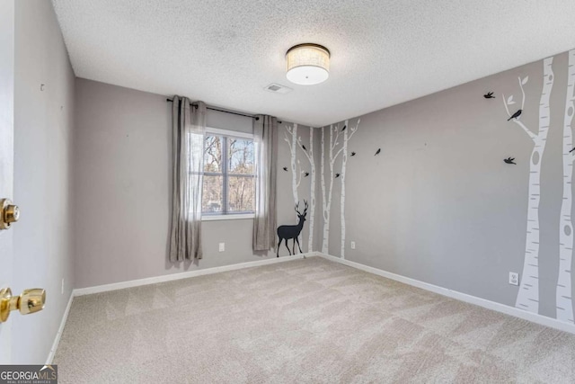 4519 Glenforest Dr NE, Roswell, GA 30075 - spare room featuring baseboards, visible vents, carpet, and a textured ceiling