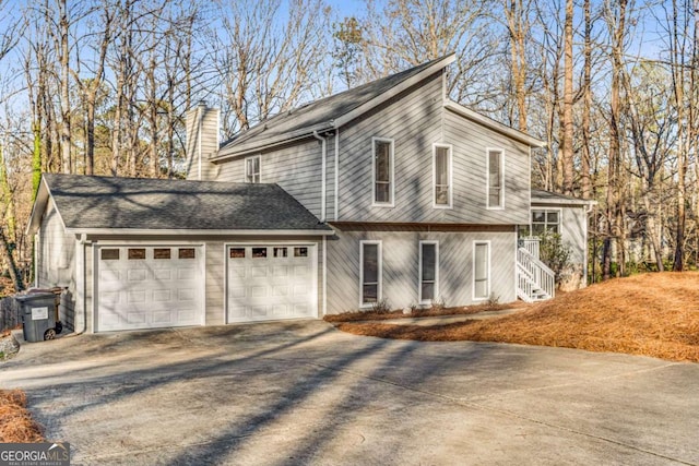 4519 Glenforest Dr NE, Roswell, GA 30075 - view of front of home with a chimney, concrete driveway, and an attached garage
