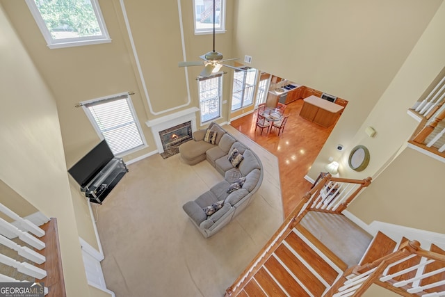 1210 Spring Branch Ct, Lawrenceville, GA 30045 - carpeted living room with a towering ceiling, a fireplace with flush hearth, plenty of natural light, and a ceiling fan