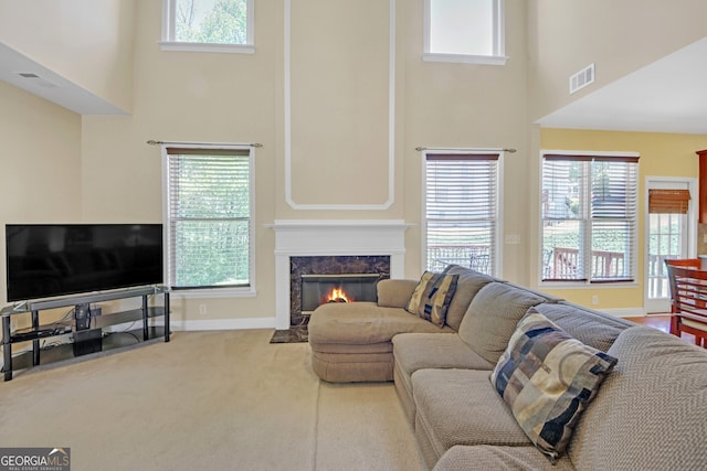 1210 Spring Branch Ct, Lawrenceville, GA 30045 - carpeted living room featuring a high ceiling and a fireplace