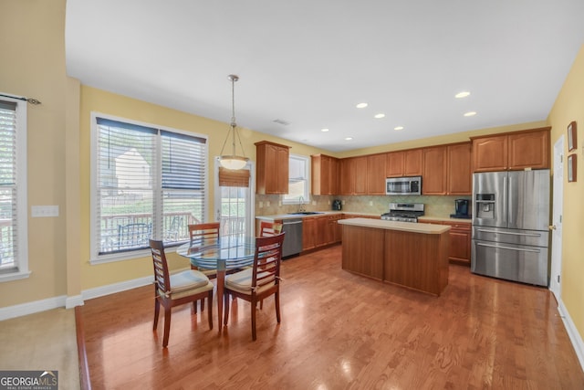 1210 Spring Branch Ct, Lawrenceville, GA 30045 - kitchen with stainless steel appliances, light countertops, healthy amount of natural light, tasteful backsplash, and recessed lighting