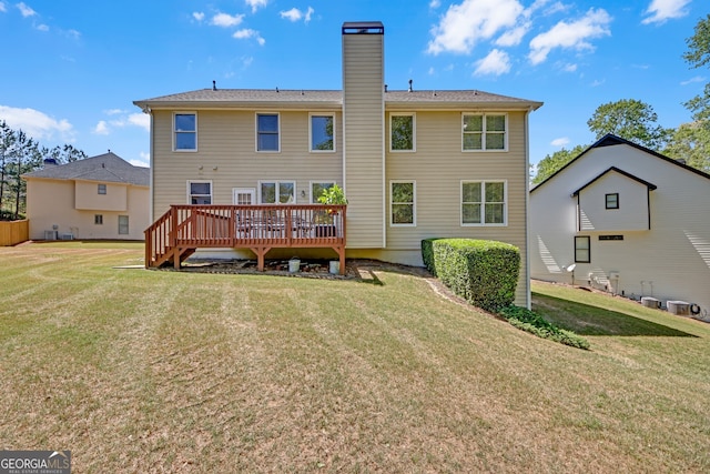 1210 Spring Branch Ct, Lawrenceville, GA 30045 - back of property with a wooden deck, a chimney, and a lawn
