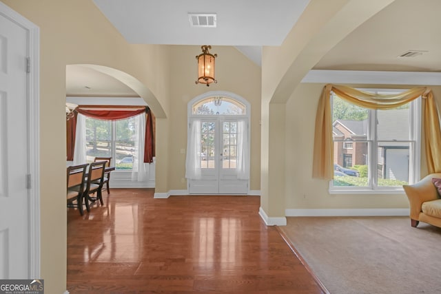1210 Spring Branch Ct, Lawrenceville, GA 30045 - entryway with arched walkways, wood finished floors, and french doors