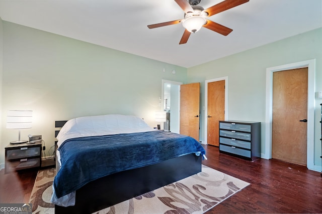 bedroom featuring baseboards, wood finished floors, and a ceiling fan