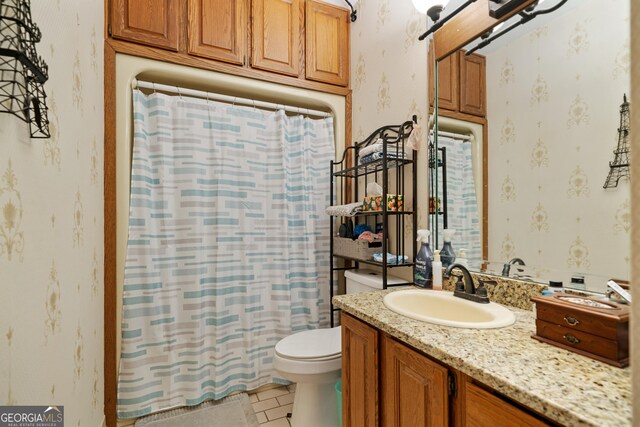 full bathroom with tile patterned floors, wallpapered walls, toilet, and vanity