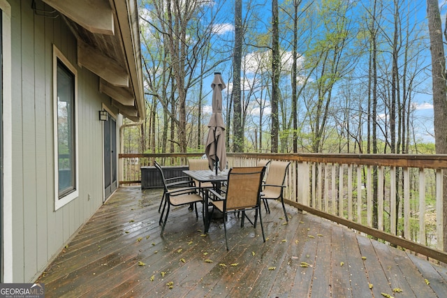 wooden terrace featuring outdoor dining space
