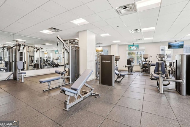 workout area with visible vents and a paneled ceiling