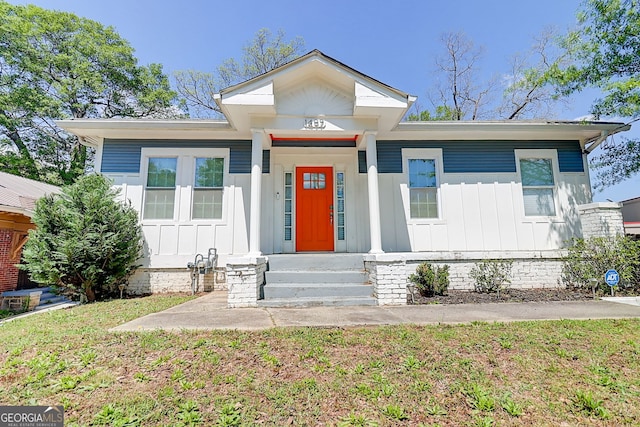 1497 Rogers Ave SW, Atlanta, GA 30310 - bungalow featuring board and batten siding, a front yard, and entry steps