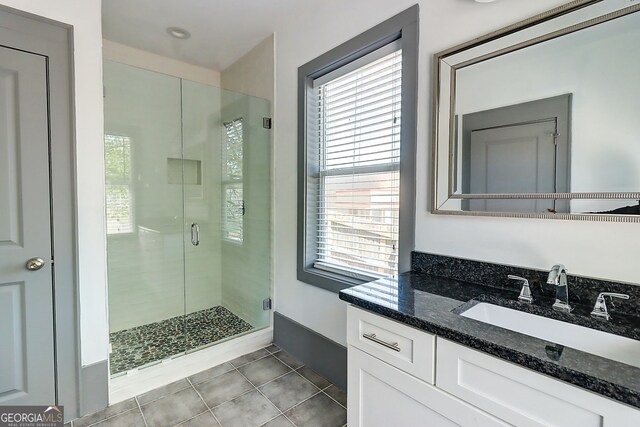 1497 Rogers Ave SW, Atlanta, GA 30310 - bathroom with tile patterned flooring, a stall shower, vanity, and baseboards