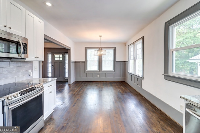 1497 Rogers Ave SW, Atlanta, GA 30310 - kitchen with stainless steel appliances, dark wood-type flooring, white cabinets, wainscoting, and recessed lighting