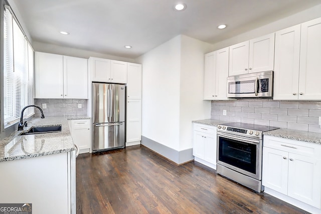 1497 Rogers Ave SW, Atlanta, GA 30310 - kitchen featuring stainless steel appliances, a sink, recessed lighting, light stone countertops, and dark wood-type flooring
