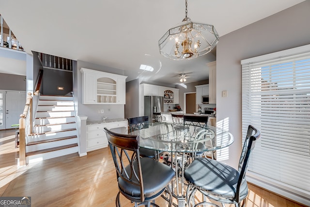 5045 Southern Trace Dr, Gainesville, GA 30504 - dining room with a ceiling fan, light wood finished floors, stairway, and a chandelier