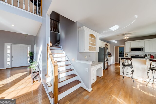 5045 Southern Trace Dr, Gainesville, GA 30504 - kitchen featuring stainless steel appliances, white cabinets, light wood-style floors, and ceiling fan