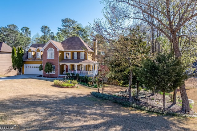 5045 Southern Trace Dr, Gainesville, GA 30504 - view of front of property featuring a porch, driveway, a garage, a chimney, and brick siding