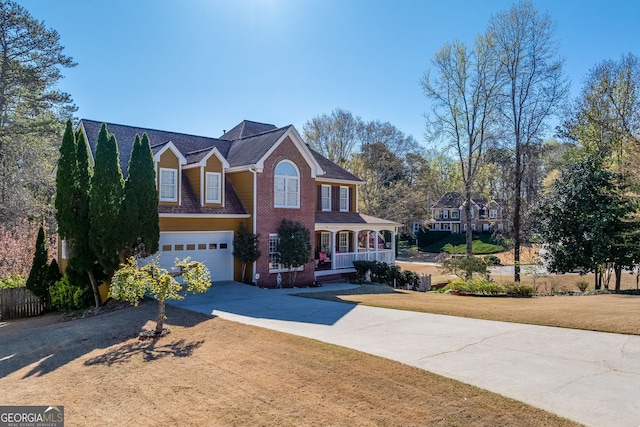 5045 Southern Trace Dr, Gainesville, GA 30504 - traditional-style home featuring a porch, concrete driveway, an attached garage, and brick siding