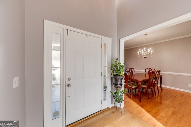 5045 Southern Trace Dr, Gainesville, GA 30504 - entryway featuring light wood-type flooring, a chandelier, crown molding, and baseboards