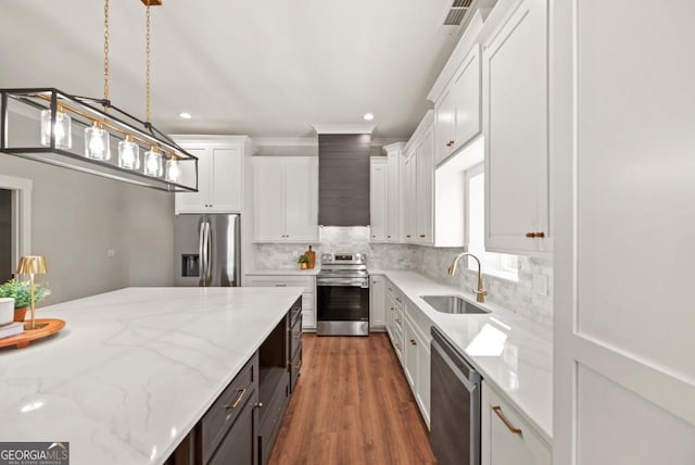 112 E Fambrough St, Monroe, GA 30655 - kitchen featuring a sink, a center island, crown molding, decorative backsplash, and recessed lighting