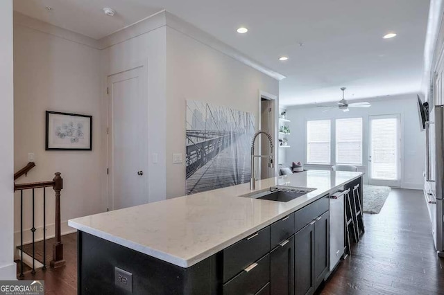 kitchen featuring dark wood-style flooring, ornamental molding, a ceiling fan, a sink, and stainless steel dishwasher
