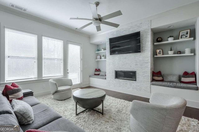 living room featuring dark wood-style floors, built in features, baseboards, and visible vents