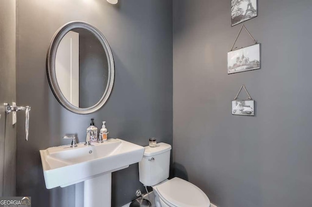bathroom featuring toilet and a sink