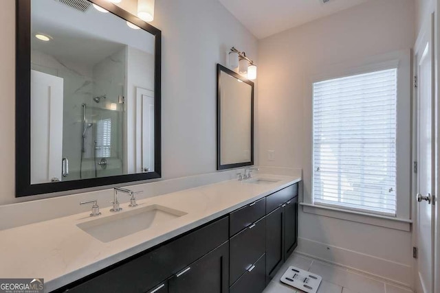 bathroom featuring double vanity, a sink, a stall shower, and visible vents