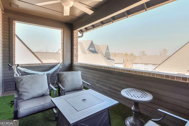 exterior space featuring a ceiling fan, a balcony, and visible vents