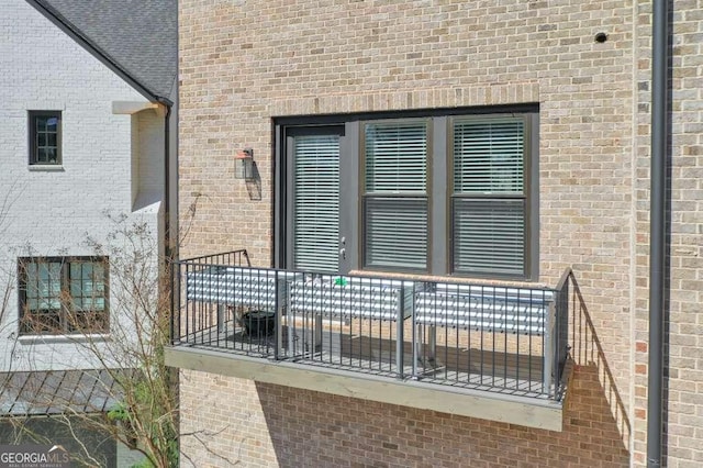 entrance to property featuring brick siding