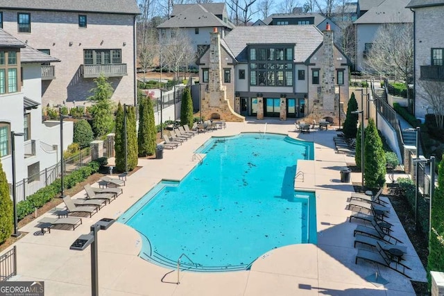 pool featuring a residential view, fence, and a patio