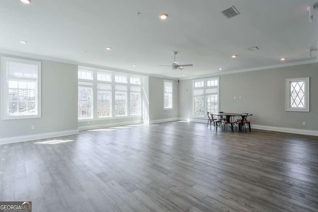 unfurnished living room with visible vents, crown molding, dark wood-style flooring, and a ceiling fan