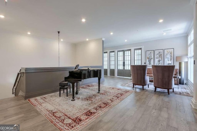 interior space featuring crown molding, baseboards, light wood finished floors, and recessed lighting