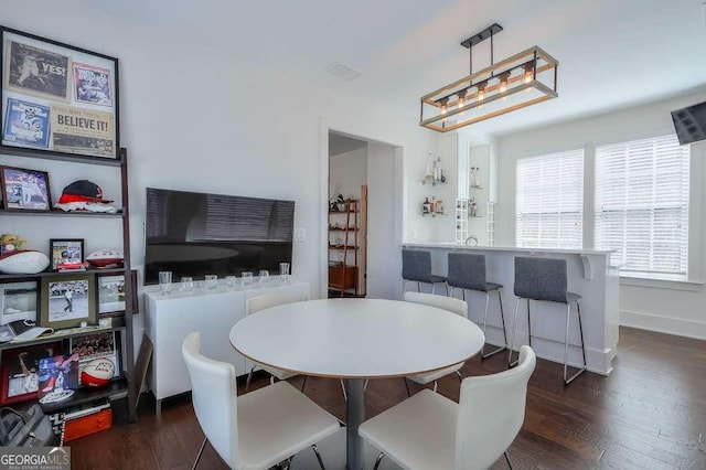 dining room with baseboards and dark wood finished floors