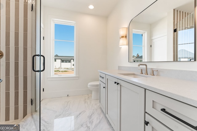 bathroom featuring vanity, baseboards, marble finish floor, and a stall shower